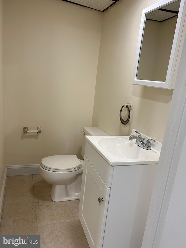 bathroom featuring vanity, toilet, and tile patterned flooring