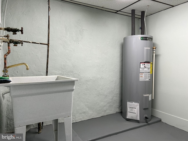 utility room with water heater and sink