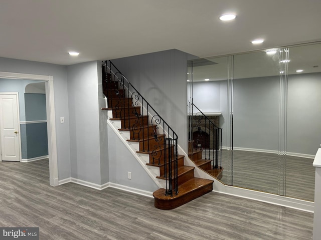 stairs featuring hardwood / wood-style floors