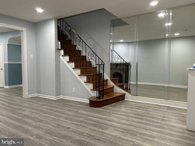 stairs featuring hardwood / wood-style flooring