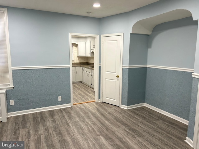 unfurnished dining area featuring dark hardwood / wood-style flooring