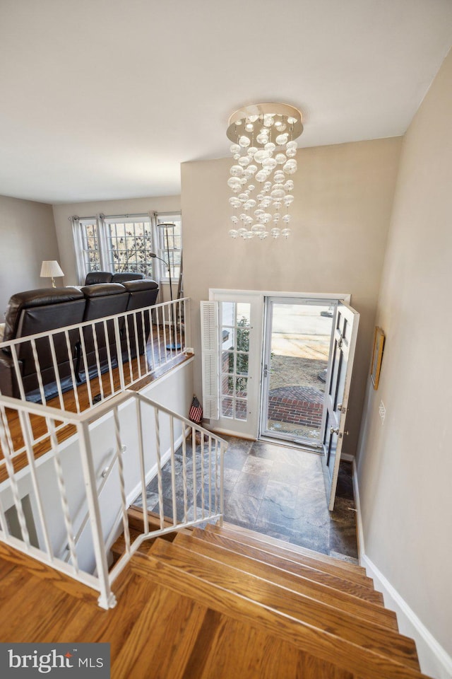 stairs with a chandelier