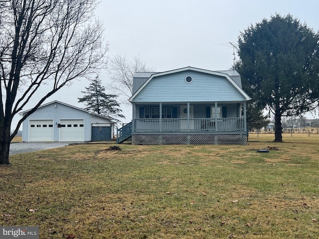 view of front of property with a garage, an outdoor structure, covered porch, and a front yard