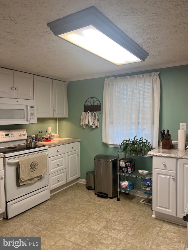30 Foggy Bottom Ln, Berkeley Springs, WV 25411 - kitchen featuring crown molding, white appliances, a textured ceiling, and white cabinets