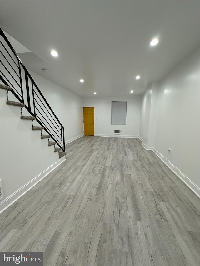 basement with light hardwood / wood-style floors