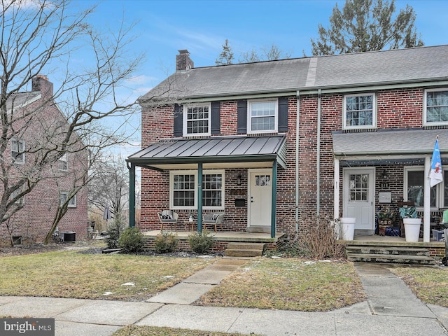 townhome / multi-family property with cooling unit, a porch, and a front lawn