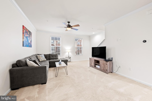 carpeted living room with crown molding and ceiling fan