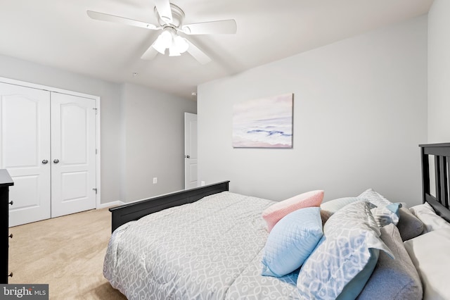 bedroom with light carpet, a closet, and ceiling fan