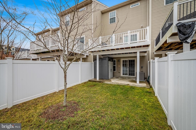 back of house with a lawn, a patio, and central air condition unit