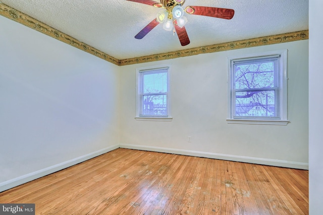 unfurnished room featuring ceiling fan, a textured ceiling, and light wood-type flooring