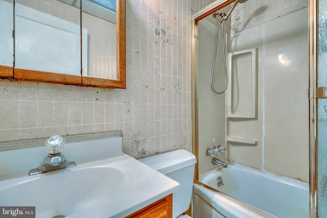 full bathroom with tub / shower combination, tile walls, vanity, decorative backsplash, and toilet