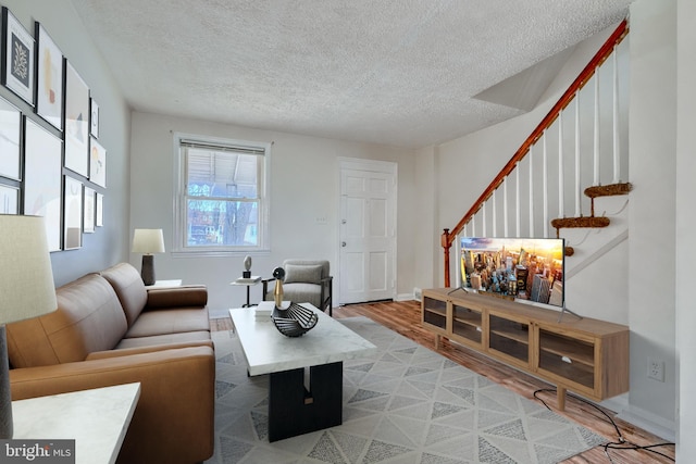 living room with hardwood / wood-style floors and a textured ceiling