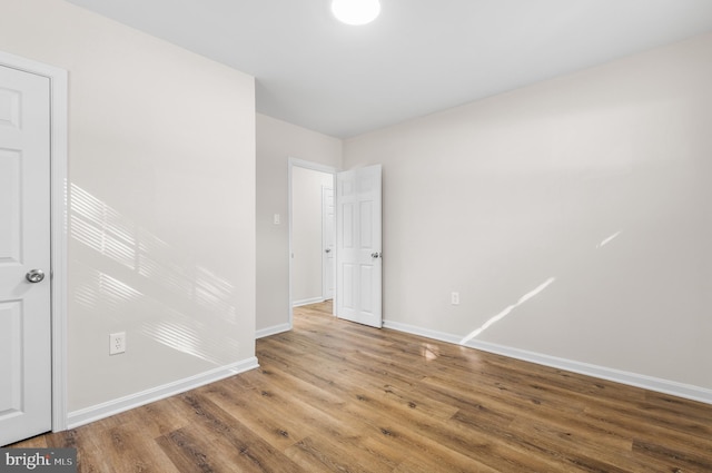 unfurnished room with wood-type flooring