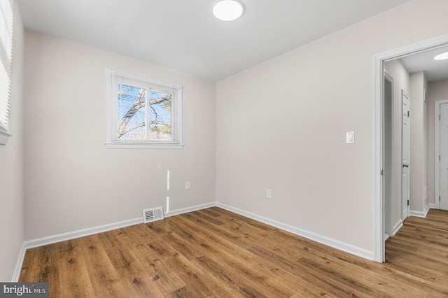 spare room featuring light wood-type flooring