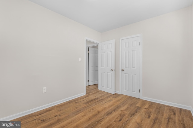 unfurnished bedroom featuring wood-type flooring