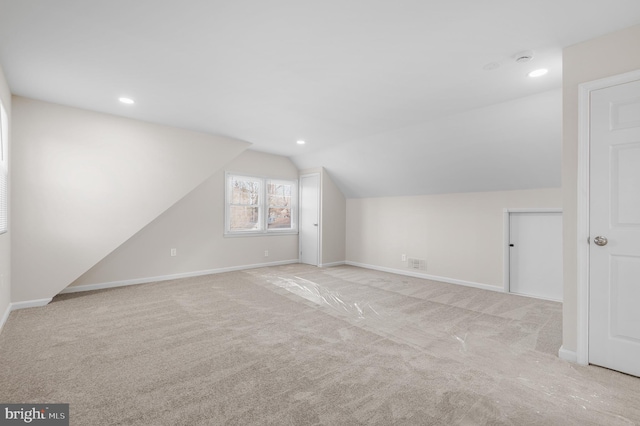 bonus room featuring vaulted ceiling and light carpet