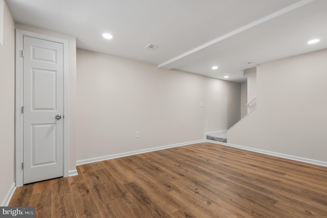 basement with hardwood / wood-style flooring