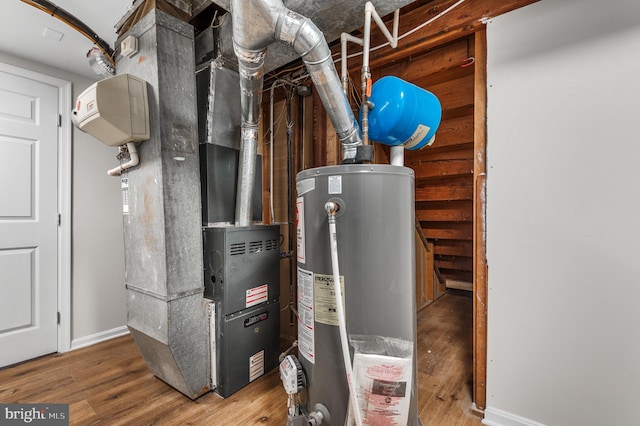 utility room featuring heating unit and gas water heater