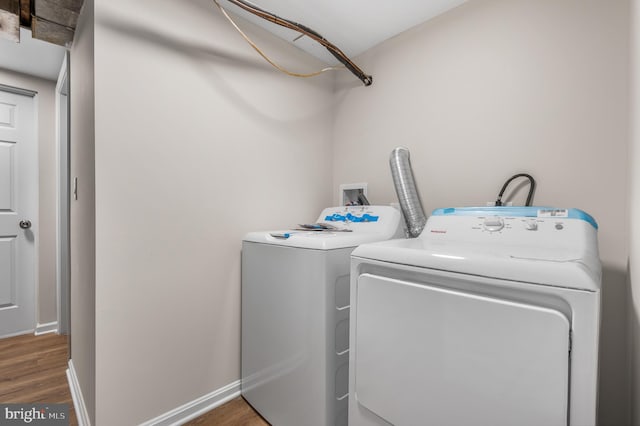 laundry room featuring dark wood-type flooring and independent washer and dryer