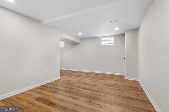 basement with hardwood / wood-style floors