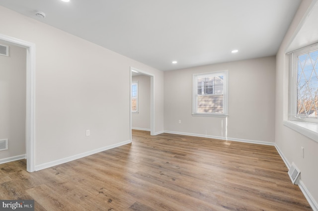 empty room featuring a wealth of natural light and light hardwood / wood-style floors