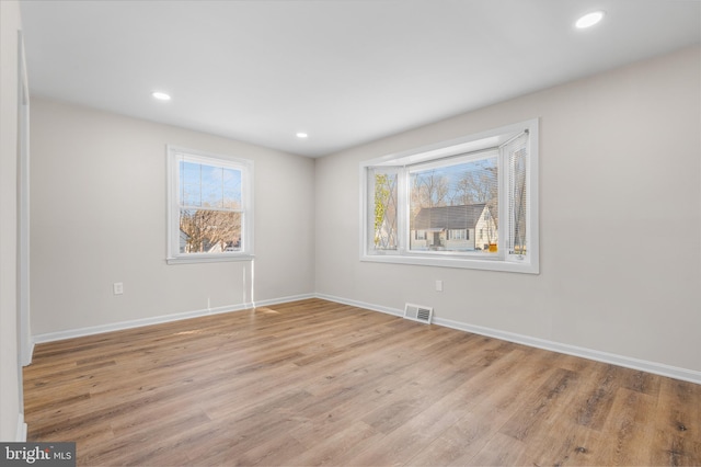 unfurnished room with light hardwood / wood-style flooring