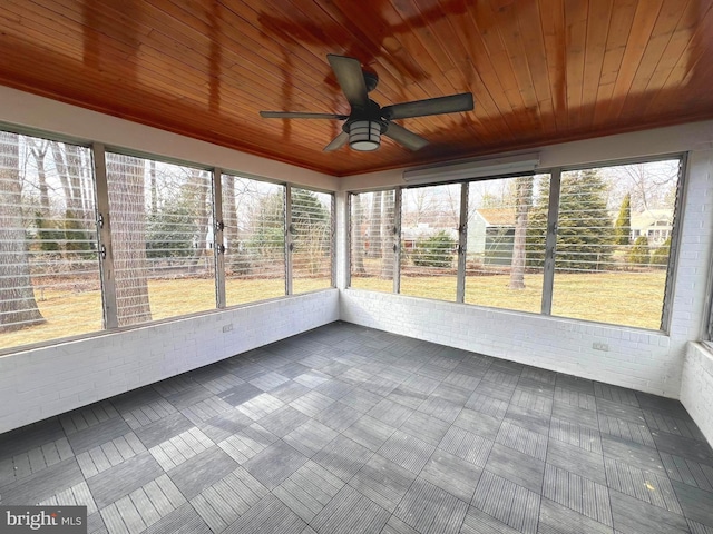 unfurnished sunroom with ceiling fan and wood ceiling