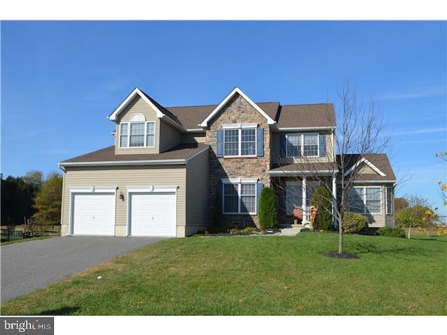 view of front of house with a garage and a front yard