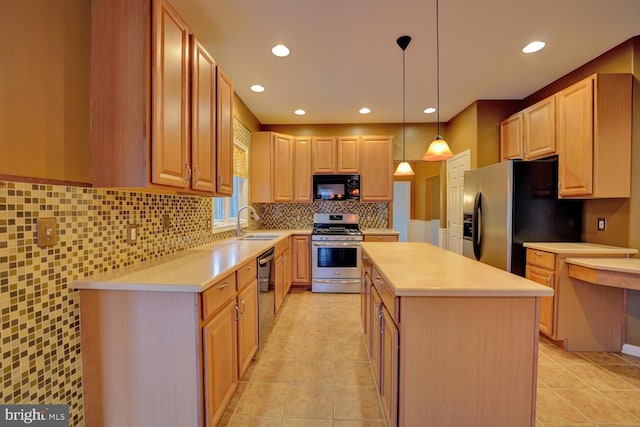 kitchen featuring a kitchen island, pendant lighting, sink, stainless steel appliances, and light brown cabinets