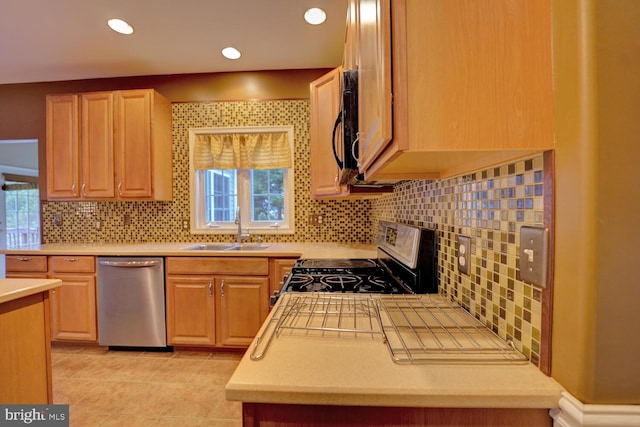 kitchen featuring stainless steel appliances, tasteful backsplash, plenty of natural light, and sink