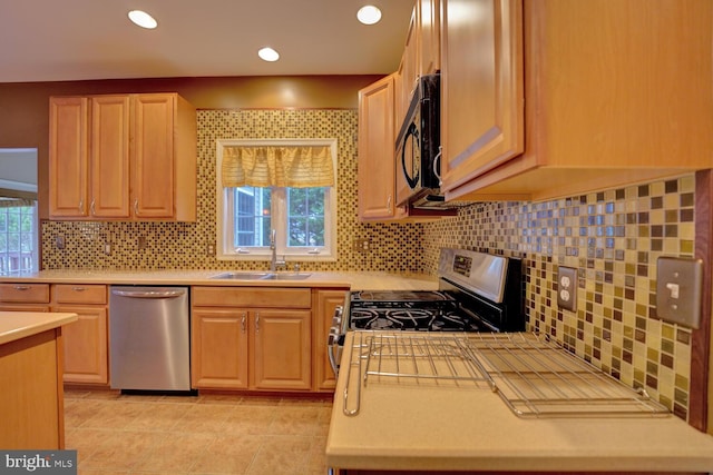 kitchen featuring appliances with stainless steel finishes, sink, a wealth of natural light, and light brown cabinetry