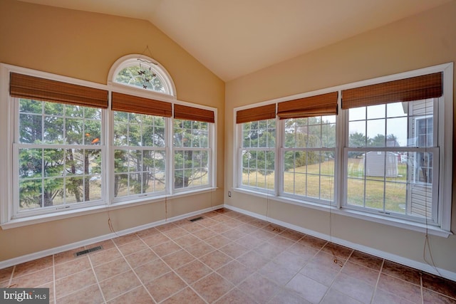 unfurnished sunroom featuring vaulted ceiling and a healthy amount of sunlight