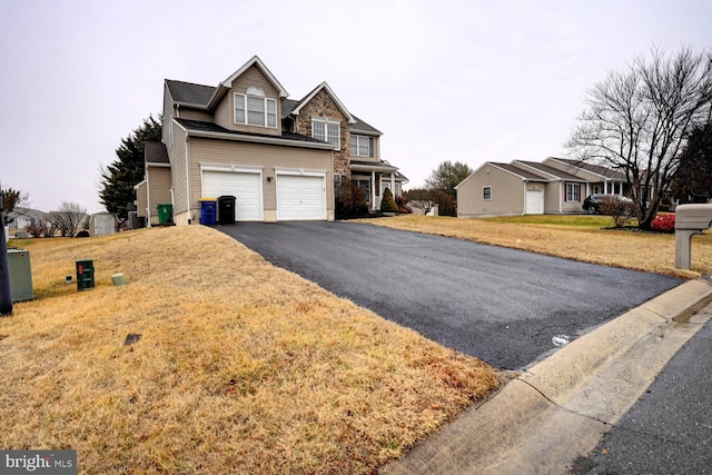 view of front of home featuring cooling unit, a garage, and a front lawn