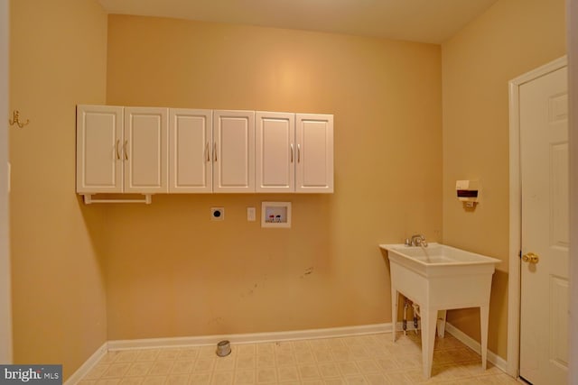 clothes washing area featuring cabinets, hookup for an electric dryer, and hookup for a washing machine