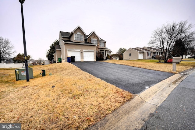 view of front of house featuring a garage and a front lawn