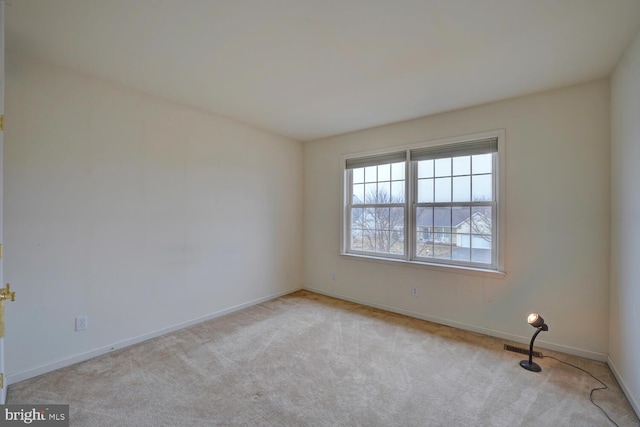 unfurnished room featuring light carpet