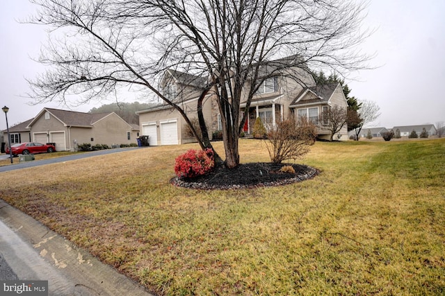 view of front of property with a garage and a front lawn