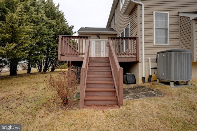 view of jungle gym with a wooden deck, cooling unit, and a lawn