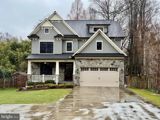 craftsman-style house with a garage, a front yard, and a porch