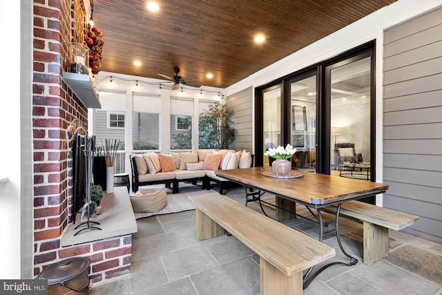 sunroom / solarium featuring ceiling fan and wooden ceiling