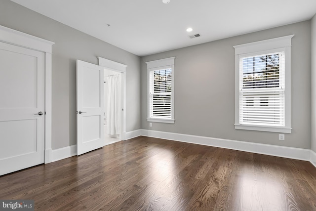 unfurnished bedroom with dark hardwood / wood-style flooring