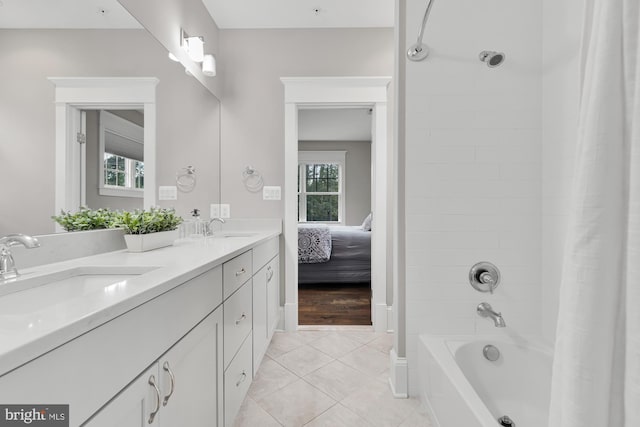 bathroom featuring tile patterned flooring, vanity, and shower / bathtub combination with curtain