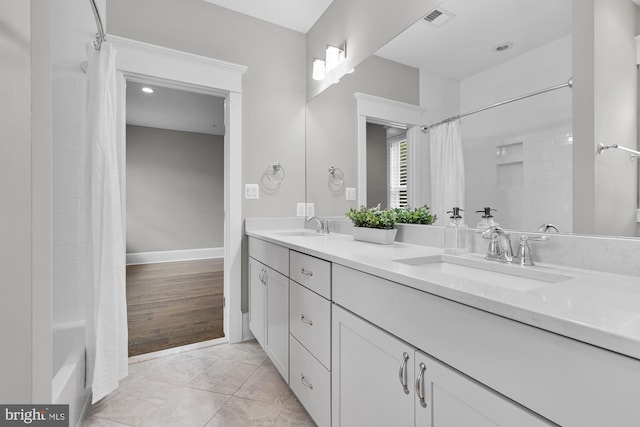 bathroom with vanity, tile patterned flooring, and shower / bath combo