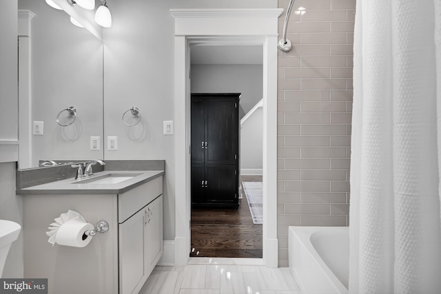 bathroom featuring shower / tub combo and vanity