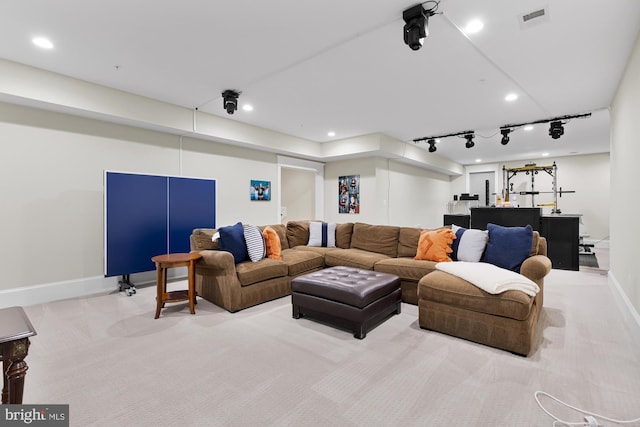 living room featuring light colored carpet and track lighting