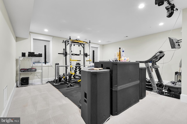 exercise area featuring light colored carpet