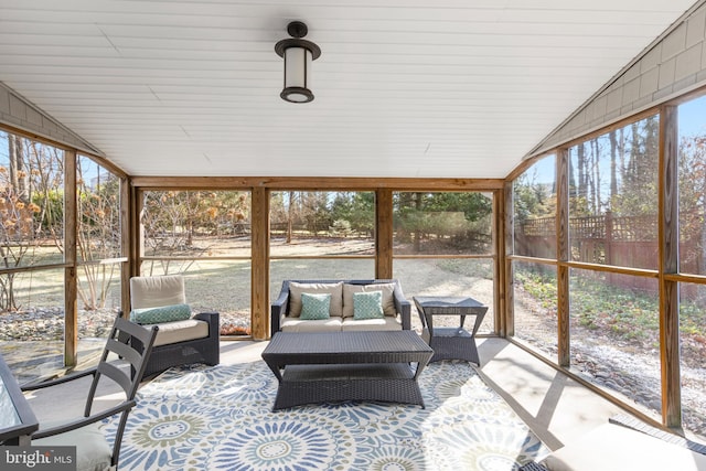 sunroom featuring lofted ceiling