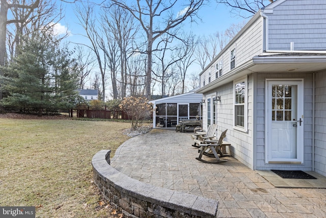 view of yard featuring a patio area and a sunroom