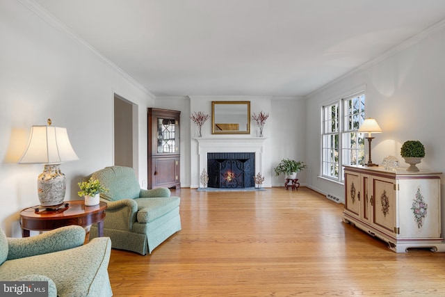 living room featuring crown molding and light hardwood / wood-style floors