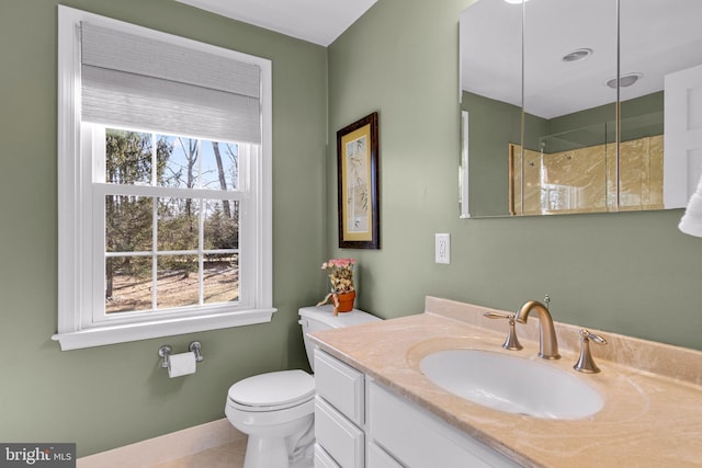 bathroom with vanity, tile patterned flooring, toilet, and a shower